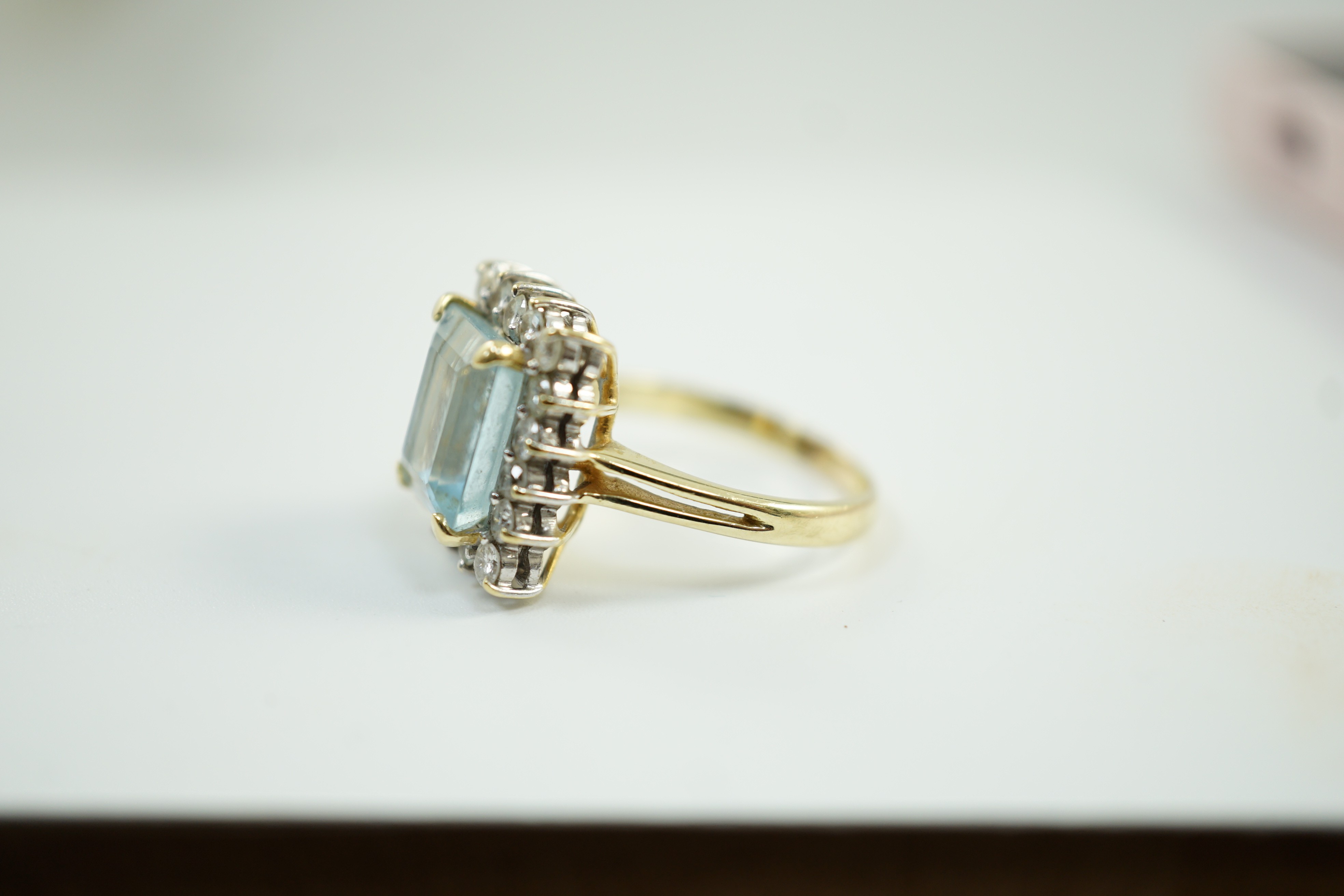 A 585 yellow metal, aquamarine and diamond set rectangular cluster ring, size N, gross weight 6.2 grams.